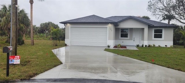 ranch-style house featuring a garage and a front yard