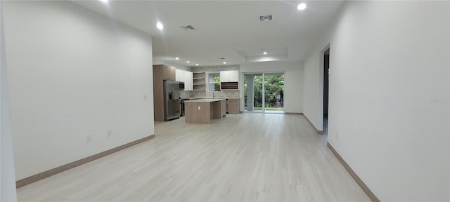 unfurnished living room with light wood-type flooring