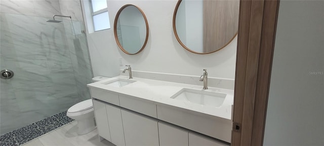 bathroom featuring vanity, toilet, and a tile shower