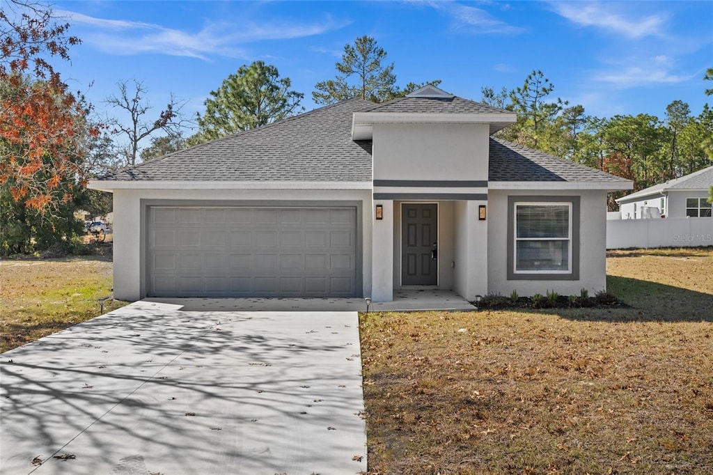 view of front facade featuring a garage and a front lawn