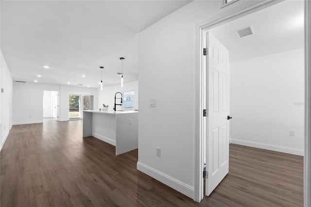 corridor featuring sink and dark hardwood / wood-style flooring