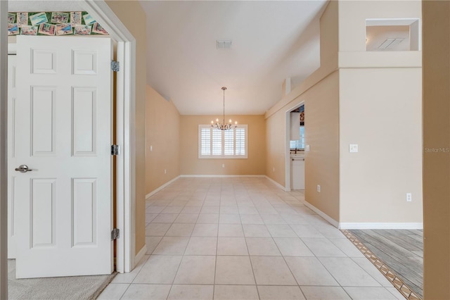 unfurnished dining area with a notable chandelier and light tile patterned flooring