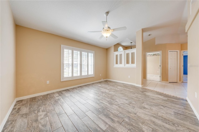 spare room featuring lofted ceiling and ceiling fan