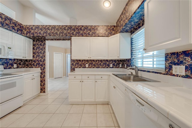 kitchen featuring white cabinetry, sink, white appliances, and tile counters