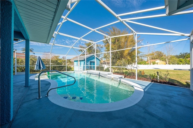 view of pool with a patio area and glass enclosure