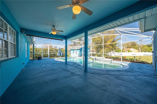 view of swimming pool featuring a lanai and a patio