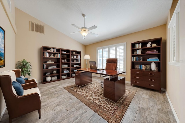 home office featuring ceiling fan, lofted ceiling, and light hardwood / wood-style floors