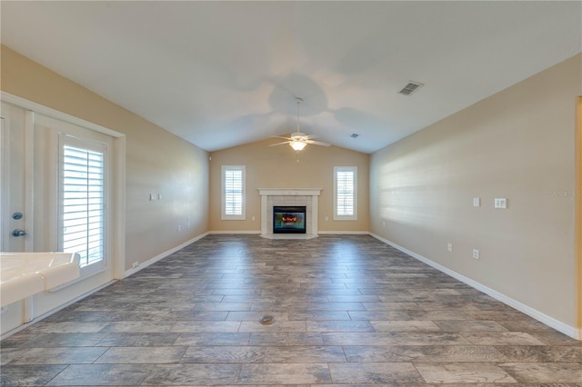 unfurnished living room featuring plenty of natural light, lofted ceiling, and ceiling fan