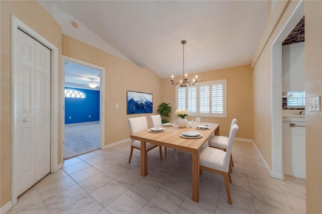 dining room with an inviting chandelier and vaulted ceiling