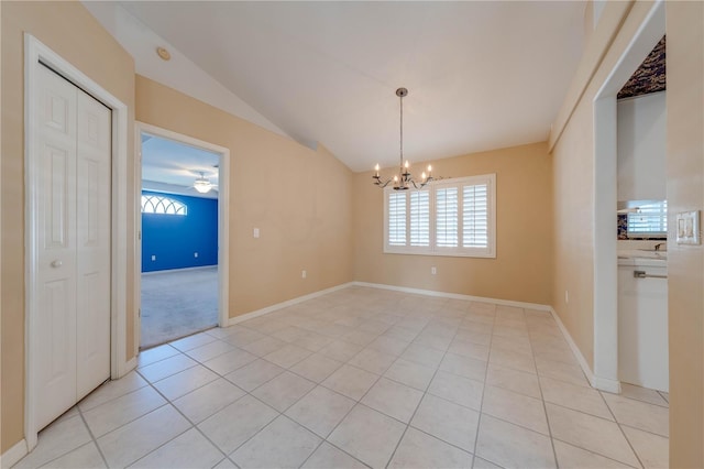 unfurnished dining area with lofted ceiling, ceiling fan with notable chandelier, and light tile patterned flooring