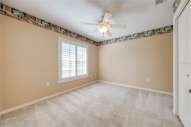 unfurnished room featuring ceiling fan and light carpet