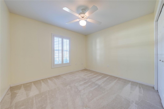 unfurnished room featuring light carpet and ceiling fan