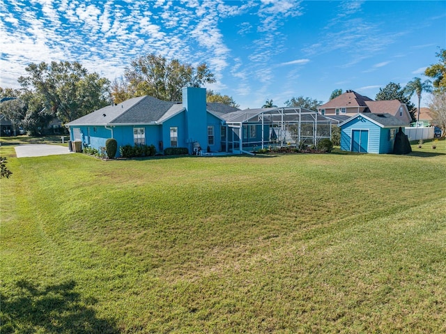 view of yard featuring a lanai and a storage unit