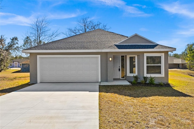 ranch-style home with a garage and a front yard