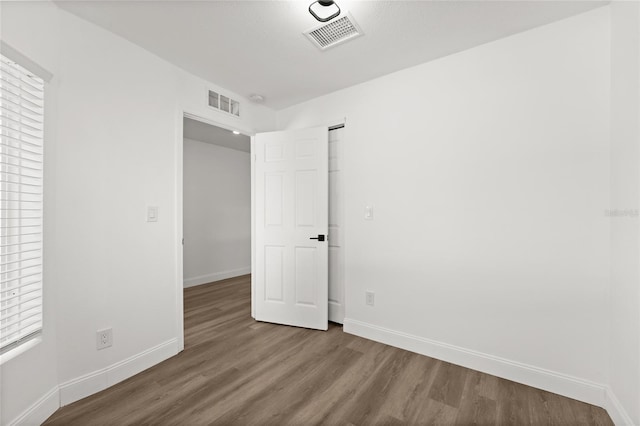 unfurnished room featuring hardwood / wood-style flooring