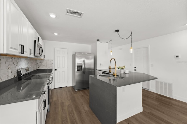 kitchen with sink, hanging light fixtures, white cabinets, and appliances with stainless steel finishes