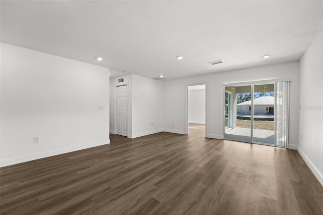 unfurnished room with dark hardwood / wood-style flooring