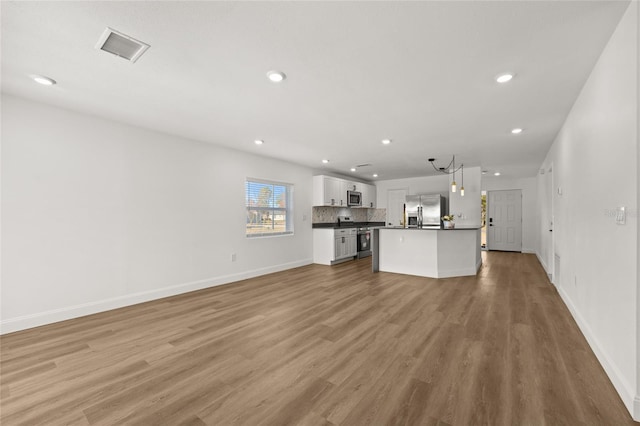 unfurnished living room with light hardwood / wood-style floors