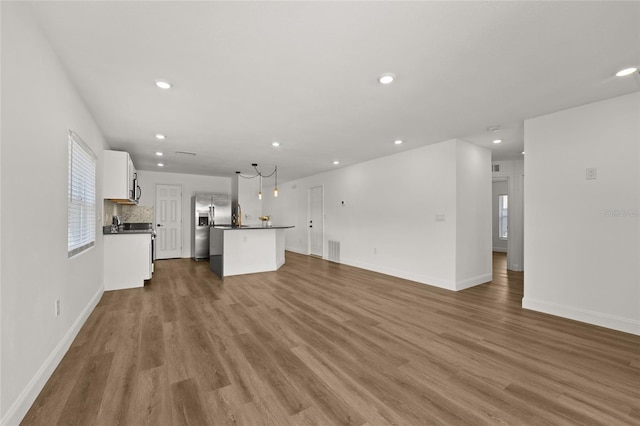 unfurnished living room featuring hardwood / wood-style flooring