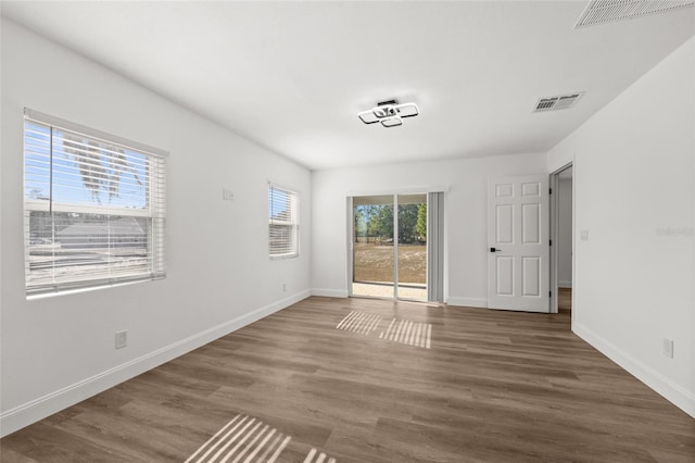 spare room featuring dark wood-type flooring