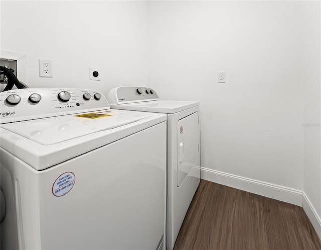 laundry area with washer and dryer and dark hardwood / wood-style floors