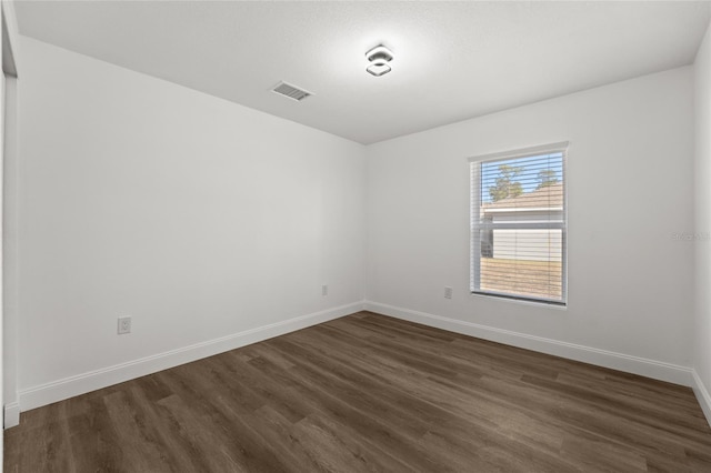 empty room with dark hardwood / wood-style floors