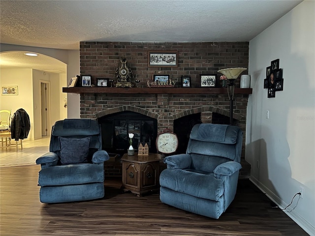 living room featuring hardwood / wood-style floors and a textured ceiling