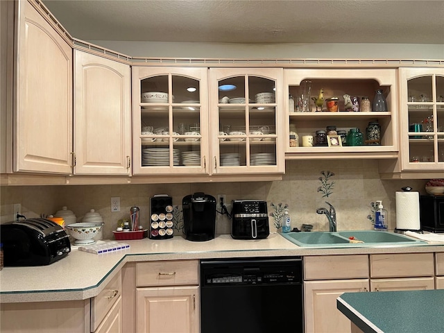 kitchen with tasteful backsplash, dishwasher, and sink