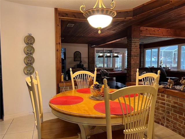 dining space featuring brick wall, light tile patterned floors, and wood ceiling