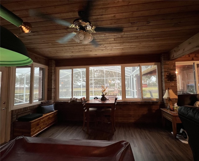 sunroom featuring ceiling fan and wooden ceiling