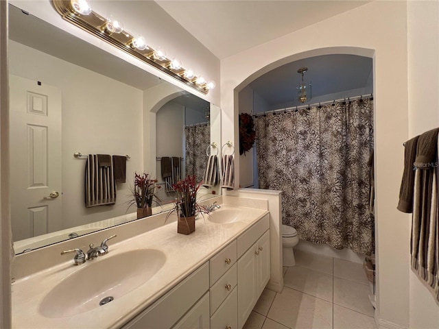 bathroom with tile patterned flooring, vanity, a shower with curtain, and toilet