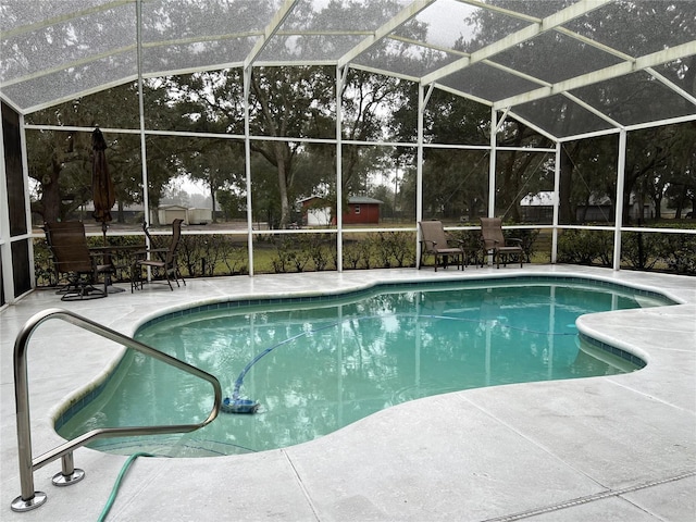 view of swimming pool featuring a patio area and glass enclosure