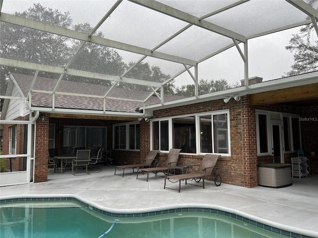 back of property featuring a patio and a lanai