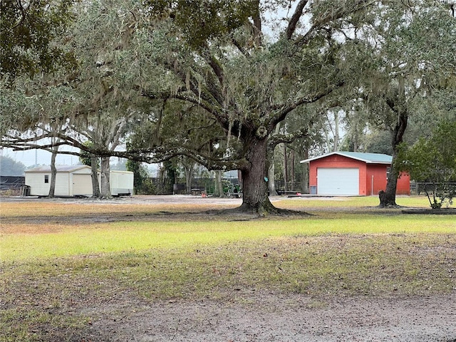 view of yard featuring an outbuilding and a garage