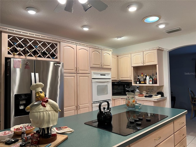 kitchen featuring black appliances, ceiling fan, and light tile patterned flooring