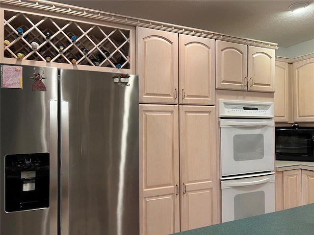 kitchen featuring stainless steel fridge and double oven