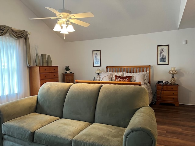 bedroom with vaulted ceiling, dark wood-type flooring, and ceiling fan