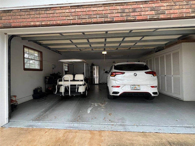 garage featuring a garage door opener and stainless steel refrigerator with ice dispenser