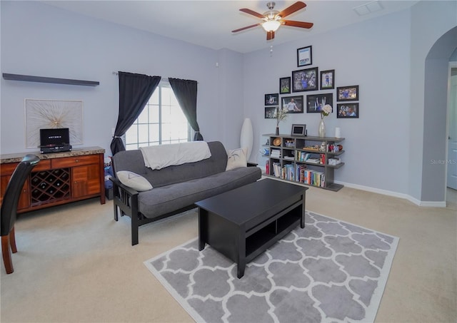 living room with light colored carpet and ceiling fan