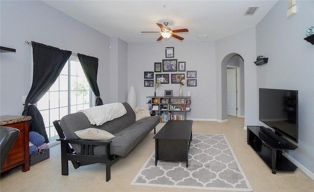 carpeted living room featuring ceiling fan