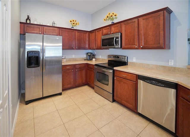 kitchen with stainless steel appliances and light tile patterned flooring