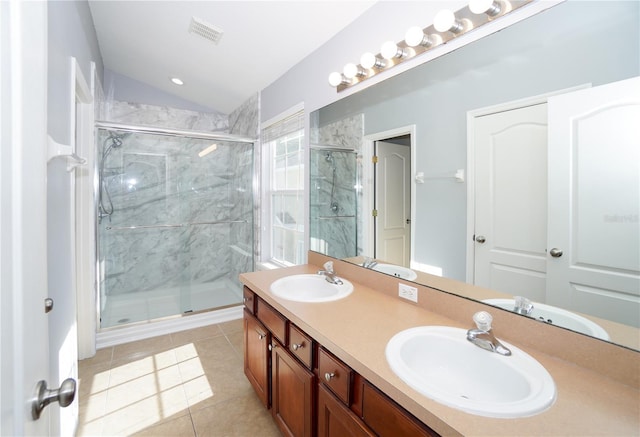 bathroom featuring a shower with shower door, tile patterned floors, vanity, and vaulted ceiling