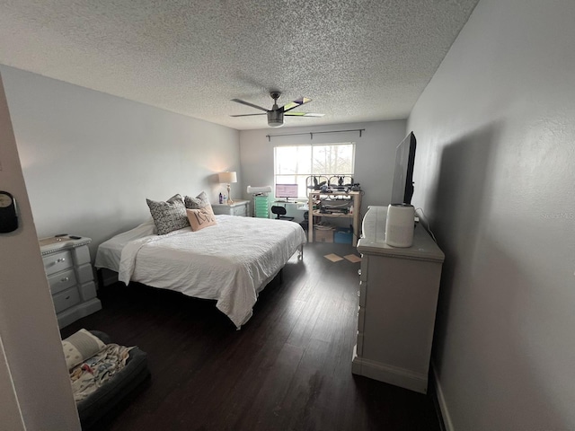 bedroom with a textured ceiling, dark hardwood / wood-style floors, and ceiling fan