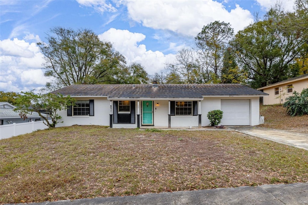 ranch-style house with a garage and a front yard