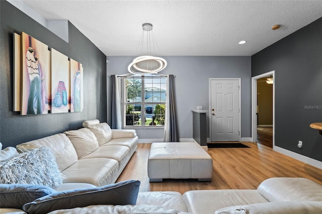 living room featuring light hardwood / wood-style floors and a textured ceiling