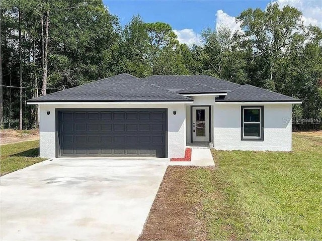 view of front of home featuring a garage and a front lawn