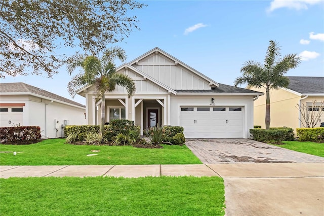 view of front of home featuring a garage and a front yard