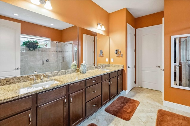 bathroom with vanity, tile patterned flooring, and a shower with door