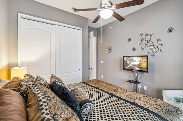 bedroom with ceiling fan and a closet