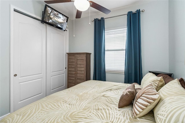 bedroom with ceiling fan and a closet